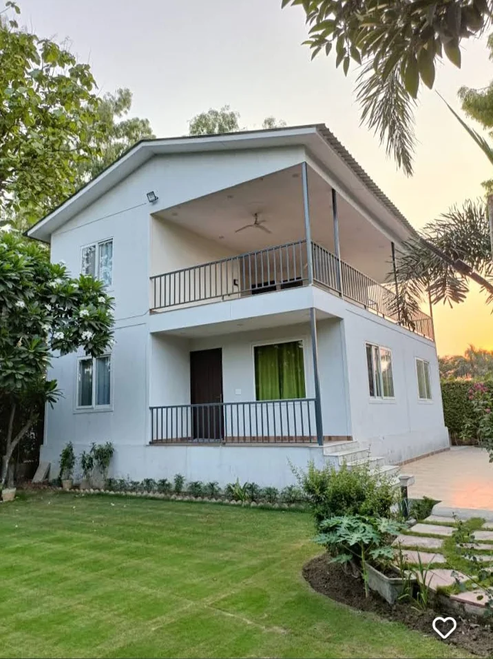 HK Farm House Noida luxury exterior at twilight